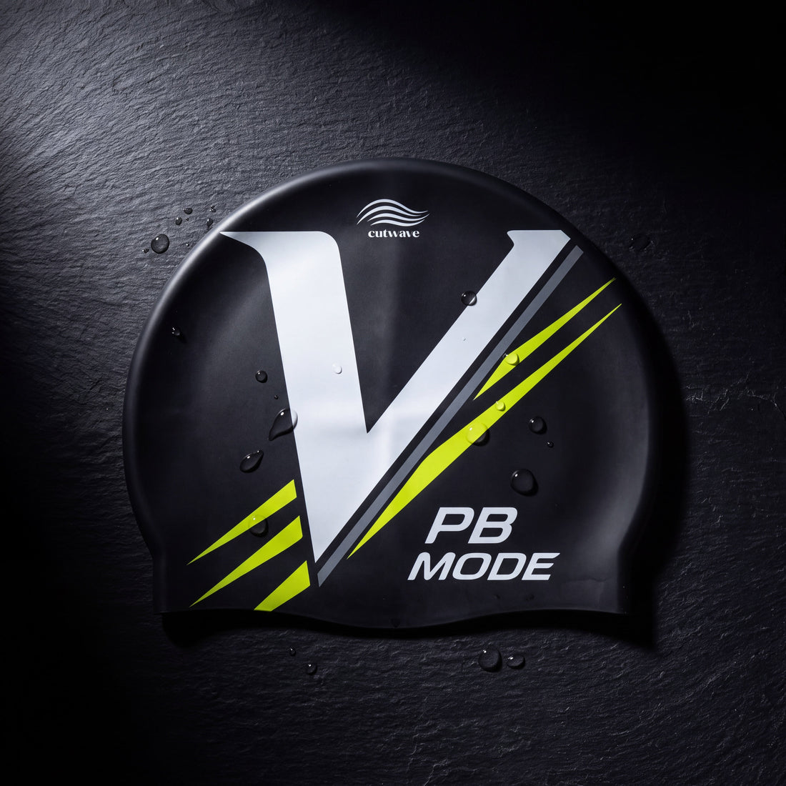 Black PB Mode silicone swim cap laid flat with its rim and smooth surface clearly visible