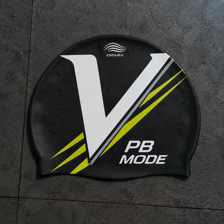 PB Mode black swim cap with a white V and lime stripes.