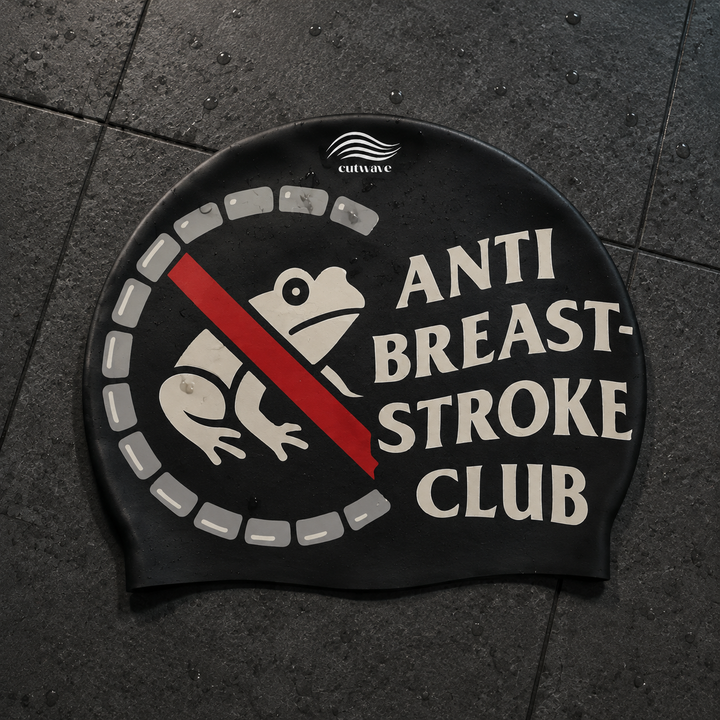 Anti Breaststroke Club black swim cap with a frog and red diagonal stripe.