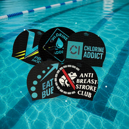 CutWave Duo Pack silicone swim caps on pool water