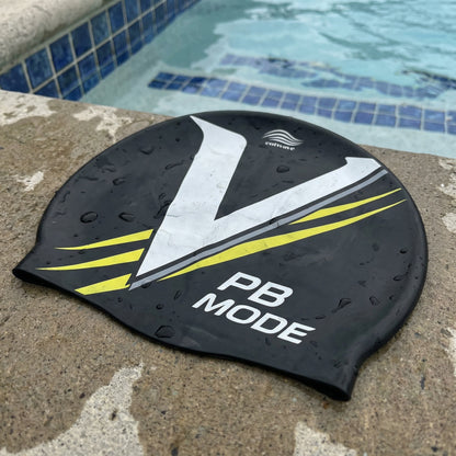 PB Mode V-design silicone swim cap by Cutwave - black with white and silver stripes on poolside