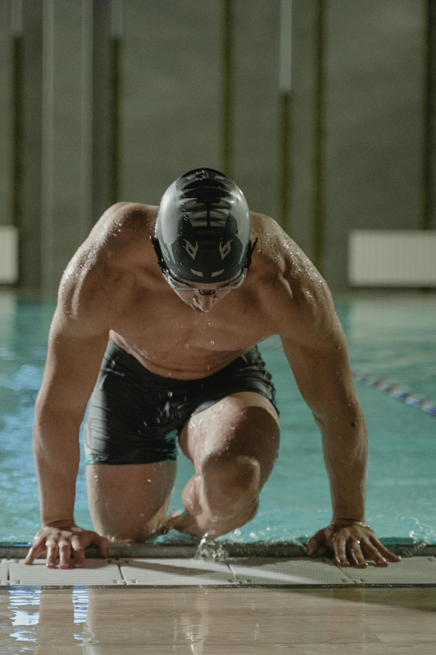 Swimmer at pool wearing a CutWave silicone swim cap